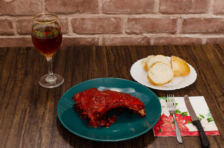 Roasted ribs marinated with barbecue sauce on wooden table.の写真素材