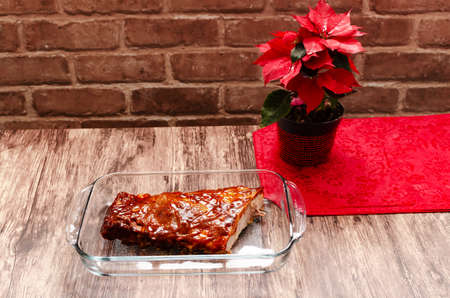 Roasted ribs marinated with barbecue sauce on wooden table.の写真素材