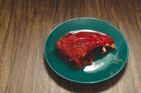 Roasted ribs marinated with barbecue sauce on wooden table.の写真素材