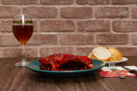 Roasted ribs marinated with barbecue sauce on wooden table.の写真素材