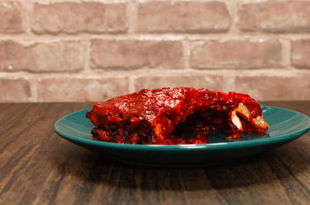 Roasted ribs marinated with barbecue sauce on wooden table.の写真素材