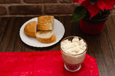 Apple salad with cream. Bowl with apple salad on wooden table with poinsettia.の写真素材
