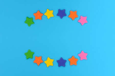 Sugar stars for cake decoration. Colorful stars on blue background.