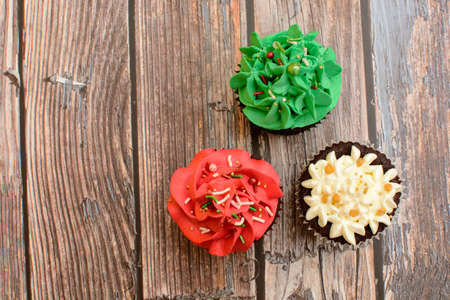 Homemade colorful cupcakes on wooden table.の写真素材