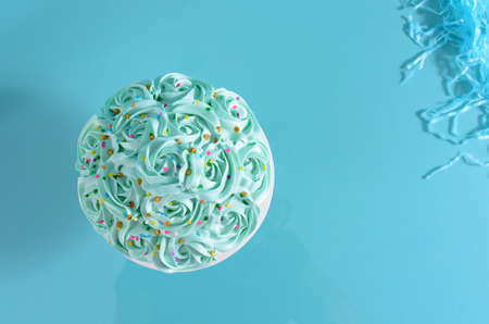 Cake decorated with blue flowers on a photo studio background.の写真素材