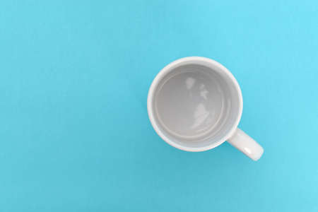 White mug on a blue background. Mug isolated.の写真素材