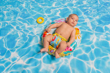 Baby enjoying in a swimming pool. Studio portrait.の写真素材
