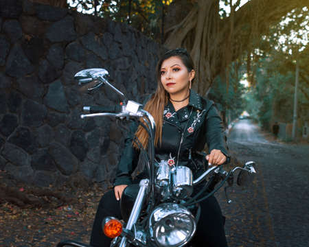 Portrait of young woman with motorcycle. Outdoor portrait of young woman with motorcycle.の写真素材