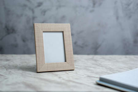 Picture frame portrait on table. Mockup.