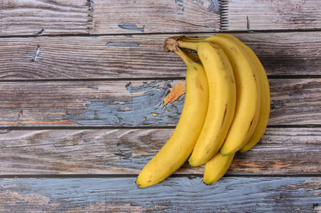 Group of ripe bananas on a wooden background. Topview.の写真素材