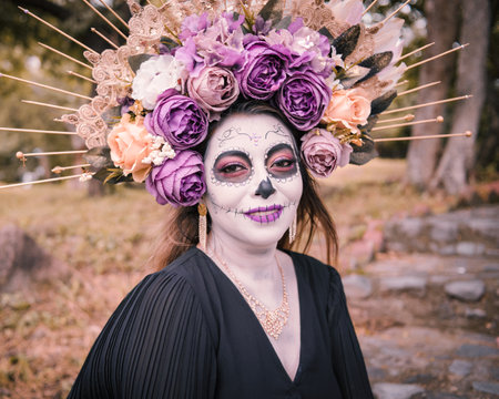 Portrait of a catrina outdoors. Typical character of the Day of the Dead celebration in Mexico.