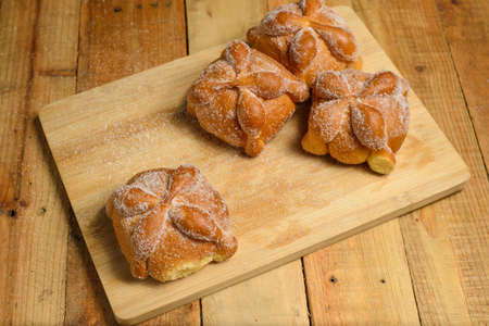 Bread of the dead on a wooden table. Typical Mexican dessert for the Day of the Dead. Top view.