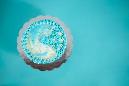 Blue and white birthday cake, top view.