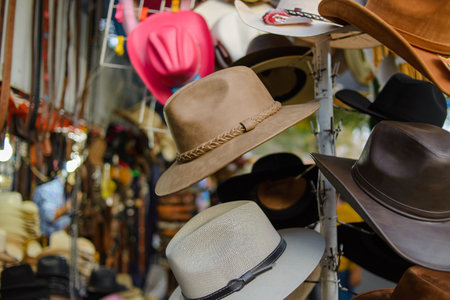 Leather hat placed on a coat rack for sale in a Mexican street market.の写真素材