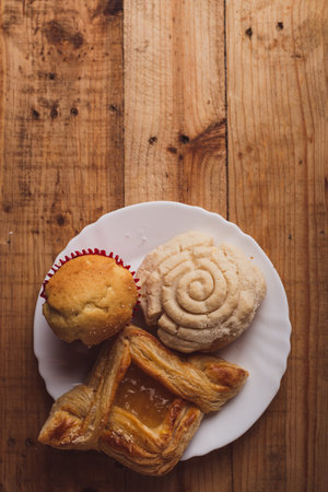 Concha and other sweet breads on wooden table. Typical Mexican desserts.の写真素材