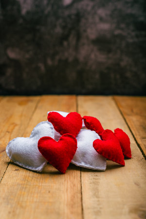 Group of hearts made of felt on wooden table. Valentine's day background.の写真素材
