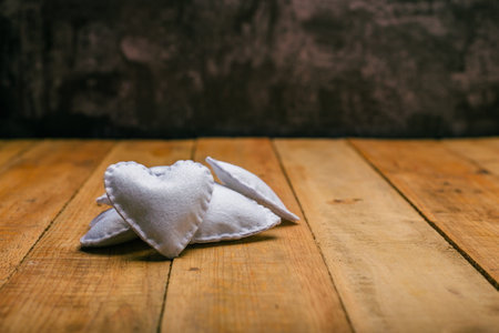 Group of hearts made of felt on wooden table. Valentine's day background.の写真素材