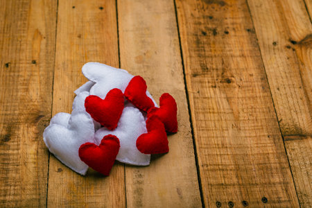 Group of hearts made of felt on wooden table. Valentine's day background.の写真素材