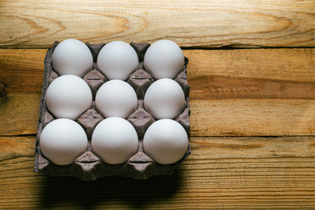 Group of eggs on wooden table. top view.