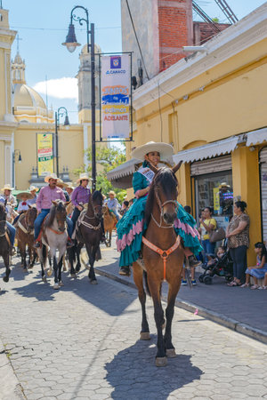 Colima, Colima, Mexico. February 11, 2023. Woman riding a horse in the horseback riding for the charro bullfighting festivities in the city of Villa de Alvarez.のeditorial素材