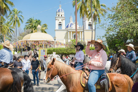 Villa de Alvarez, Colima, Mexico. February 11, 2023. Group of people on horseback in the horse parade for the charro bullfighting festivities in the city of Villa de Alvarez.のeditorial素材
