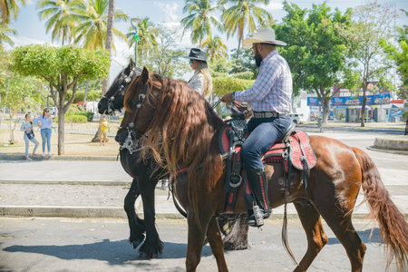 Villa de Alvarez, Colima, Mexico. February 11, 2023. Group of people on horseback in the horse parade for the charro bullfighting festivities in the city of Villa de Alvarez.のeditorial素材