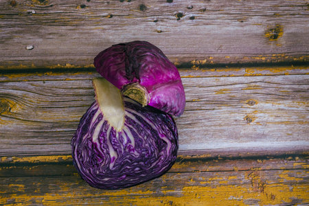 Cut purple cabbage on wooden table.