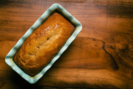 Pound cake in blue mold on wooden table.の写真素材