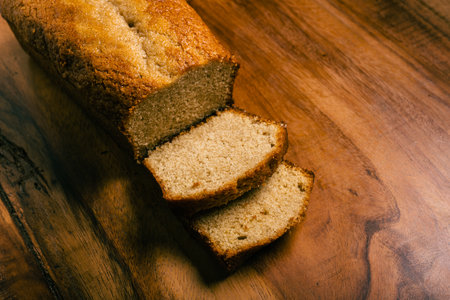 Homemade sponge cake on wooden table. Sliced soft pound cake.