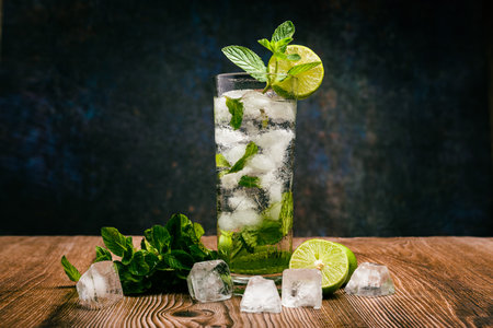Mojito, cocktail decorated with lemon and peppermint on a wooden table. No straw.の写真素材