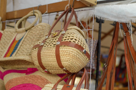 Bags made with woven palm fiber in a mexican street handicraft market.の写真素材