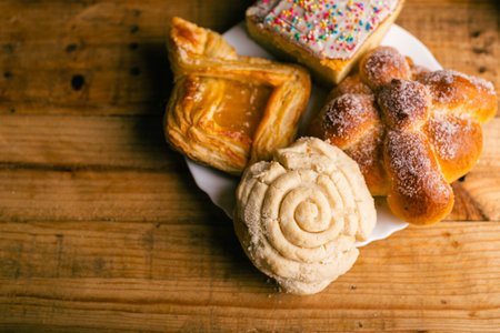 Concha and other sweet breads on wooden table. Typical Mexican desserts.