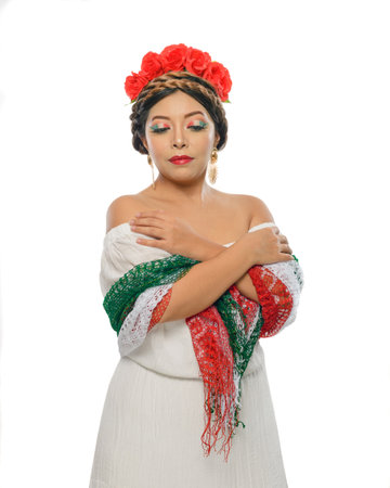 Mexican woman with scarf and tricolor make-up wearing white dress. Woman with scarf and makeup with the colors of the Mexican flag. White background.の写真素材