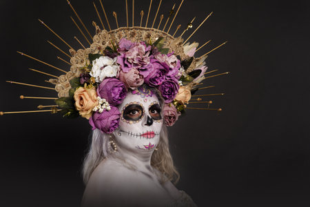 Studio portrait of woman in catrina makeup wearing wedding dress. Sugar skull make up.の写真素材
