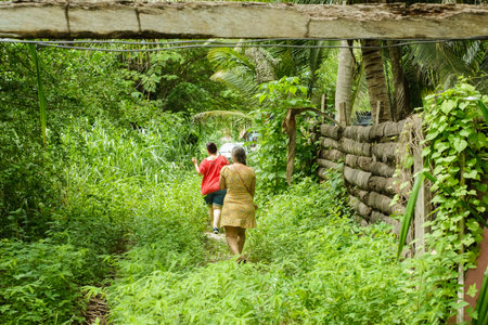 Women walking through the bush in the field.の写真素材