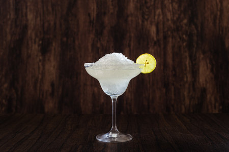 Daisy flower; classic Mexican cocktail. Cocktail isolated on dark background. Margarita frappe.の写真素材