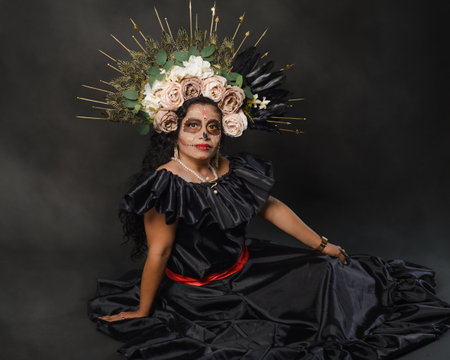 Catrina wearing a black dress. Mexican woman with catrina makeup. Day of the dead and halloween makeup.の写真素材
