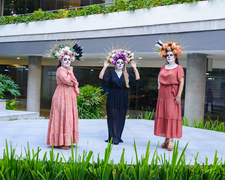 Women made up as catrinas. Day of the dead and Halloween makeup. Outdoor group portrait of three womenの写真素材