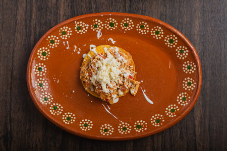 Authentic mexican chicken tinga with fresh cheese and cream on toast.の写真素材