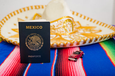 Mexican passport, mariachi hat and small car on colorful serape. Travel concept.の写真素材