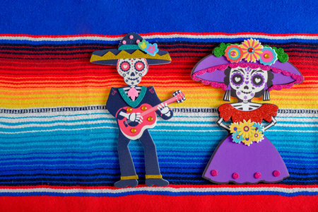 Catrina and catrin figures on colorful serape. Day of the Dead Celebration.