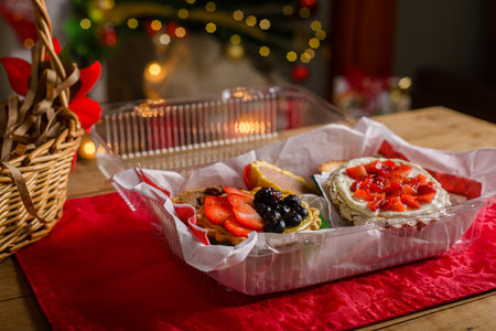 Sweet canapes on a table with a Christmas background. Red fruit desserts.の写真素材