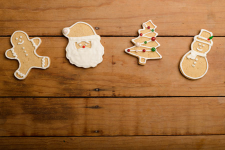 Gingerbread cookies with different figures on a wooden table. Christmas dessert.