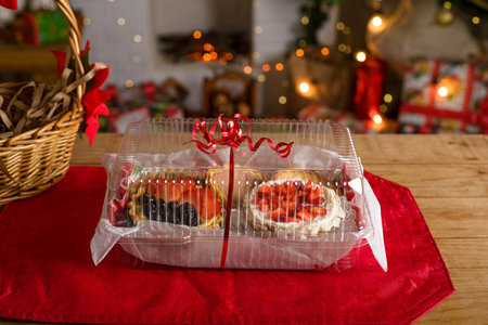 Sweet canapes on a table with a Christmas background. Red fruit desserts.の写真素材