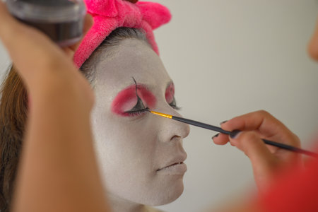 Woman being made up as a clown.の写真素材