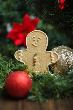 Gingerbread man cookie and ornaments on a Christmas tree. Christmas background, selective focus.の写真素材