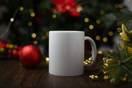Mockup of coffee cup on table with christmas decoration. Coffee mug with christmas background.の写真素材