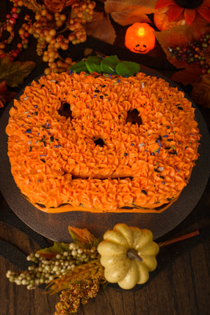 Cake decorated in the shape of a pumpkin with autumn decorations. Autumn background.の写真素材