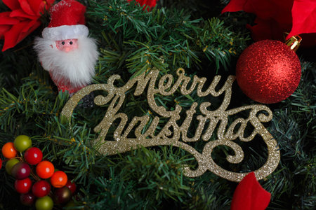 Merry Christmas sign with Christmas tree decorations. Christmas background, selective focus.