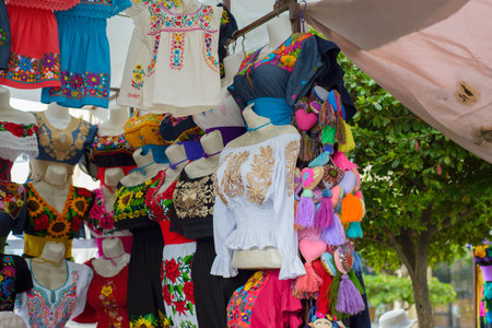 Traditional Mexican clothing with handmade embroidery. Stall in a market in Mexico.の写真素材